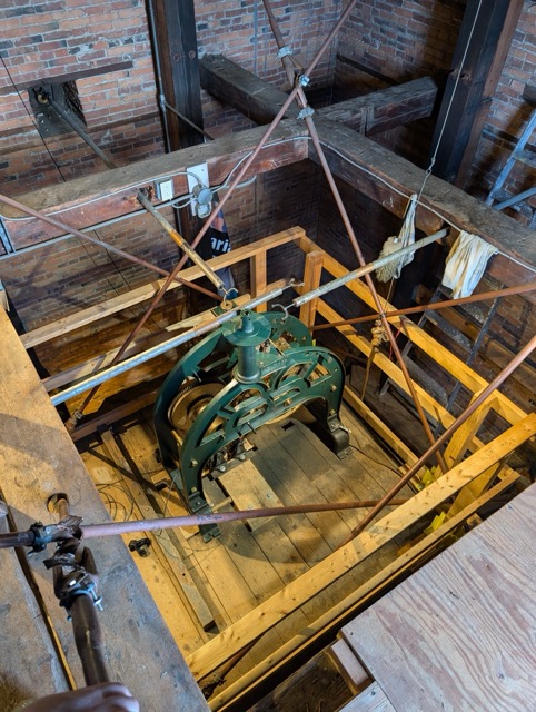 Mechanical tower clock movement in a tower room